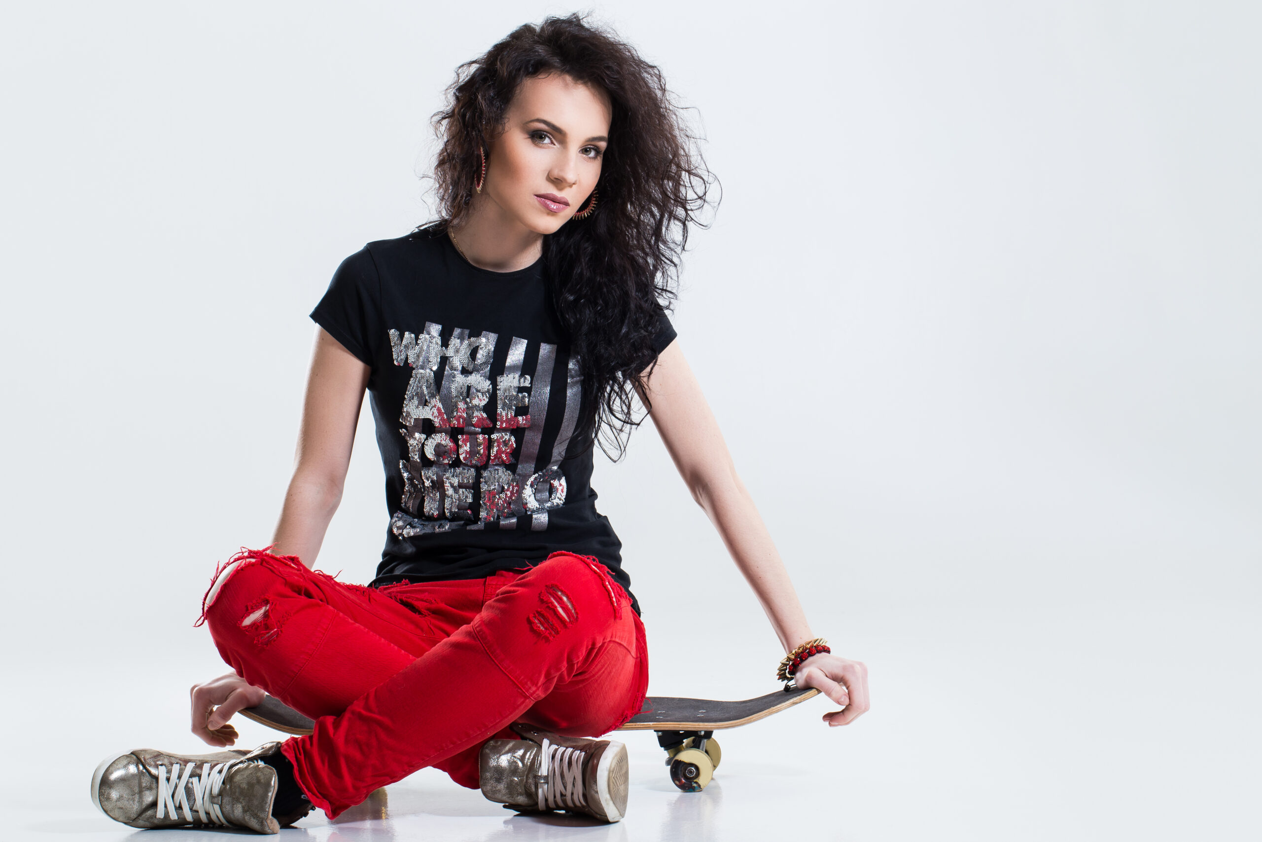 Teenager with skateboard on a white background
